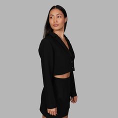 The 'Blvck Cropped Blazer' features a cropped design with a lapel neckline, as well as two engraved snake buttons. The model wears a size XS and is 173cm. True to size fit. Fabric: 70% polyester 26% cotton 4% spandex Classic Cropped Jacket For Evening, Tailored Cropped Jacket With Buttons, Cropped Office Jacket With Button Closure, Formal Cropped Buttoned Jacket, Formal Cropped Jacket With Buttons, Black Cropped Blazer With Button Closure, Black Single-breasted Cropped Jacket, Formal Black Cropped Jacket, Fitted Cropped Jacket With Lapel Collar And Buttons