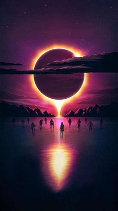 people walking on the beach at night with an eclipse in the sky above them and mountains