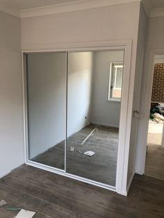 an empty room with sliding glass doors in it