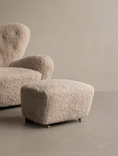 a chair and footstool made out of sheep's wool, sitting side by side