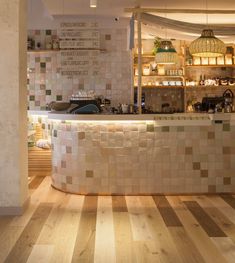 a kitchen with wooden floors and tiled walls