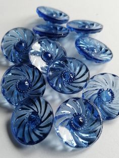 blue and white swirl glass buttons on a white surface