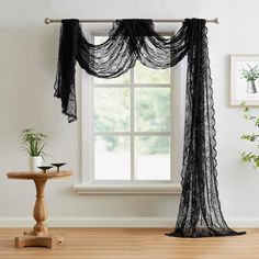 black sheer curtains hanging in front of a window