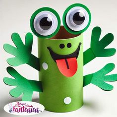 a green tube with googly eyes and tongue sticking out from it's mouth