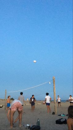 people are playing volleyball on the beach