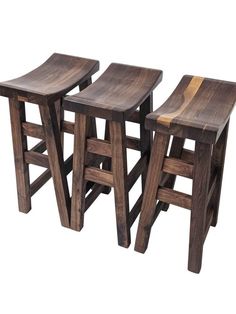 three wooden stools sitting next to each other