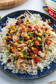 a blue plate topped with rice and beans