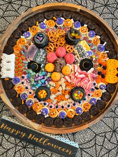 a wooden bowl filled with lots of halloween decorations