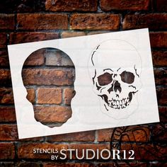 a paper cut out of a skull next to a brick wall