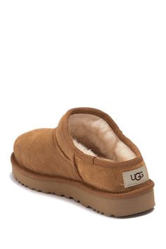 UGGplush, a moisture-wicking textile made from a wool-rich blend but crafted to feel and wear like genuine shearling, lines a timeless suede slipper designed with a rugged sole for indoor or outdoor wear. Slight dye transfer may occur with darker colors during first few wears Leather upper/UGGplush wool blend lining/synthetic sole Imported Ugg Slipper Outfit, Ugg Classic Slipper, Slipper Outfit, Cute Uggs, Slippers Outfit, Trendy Shoes Sneakers, Classic Slippers, Shoe Wishlist, Cute Nike Shoes