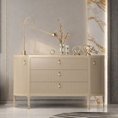 a white and beige dresser in a room with marble walls, flooring and rug