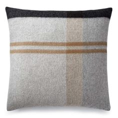 a gray and brown plaid pillow on a white background