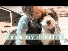 a woman kissing her dog in front of a white truck with the words how i groom my doodles on it