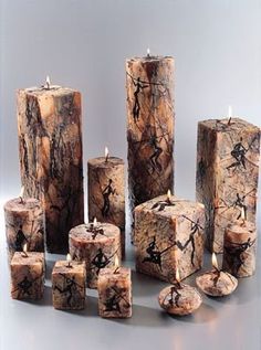 several candles made out of wood with different shapes and sizes