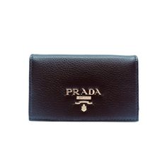 This Pradavitello grain blackcard holder is absolutely adorable and is the perfect size for your personal information. Thepebbled soft leather is sure be the classic accessory you need. The gold Prada Paris logo looks amazing with thesimple black leather. Includes authenticity cards and Prada box. Model: 1MC122 Measurements: 4.5 x 1 x 2.5 inches Black vitello grainleather Card holder/ wallet Gold Prada logo Includes authenticity cards and Prada box Size: one size.  Gender: female.  Age Group: ad Everyday Wallets With Logo Plaque, Black Rectangular Card Holder With Logo Plaque, Black Wallets With Logo Plaque For Everyday Use, Classic Black Card Holder With Logo Plaque, Black Leather Card Holder With Logo Plaque, Leather Card Holder With Logo Plaque For Everyday, Leather Wallets With Logo Plaque For Everyday, Leather Wallets With Logo Plaque, Elegant Black Card Holder With Logo Plaque