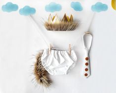 a baby's diaper with a crown on it next to a toothbrush