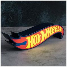 a skateboard shaped like the back end of a surfboard with flames on it