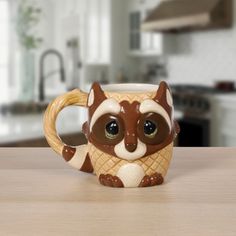 There is no masking the cuteness of this figural raccoon mug. Perfect for enjoying a warm or cold beverage, it is both comfortable to hold and sweet to look at. A sweet-faced raccoon offers its approval with each sip taken. Too cute for a cabinet, it looks great on a counter holding spoons or utensils, too. Give this generously sized raccoon mug as a thoughtful present to your favorite tea or coffee drinker or fill with chocolates or sweets for a tasty gift. Measuring approximately 4.25”H and ho Precious Moments Christmas, Christmas Raccoon, Coffee Drinker, Timeless Brand, Enjoy Coffee, Housewarming Present, Coffee Drinkers, Tea Or Coffee, Hand Painted Porcelain