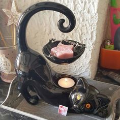 a black cat tea light holder on display