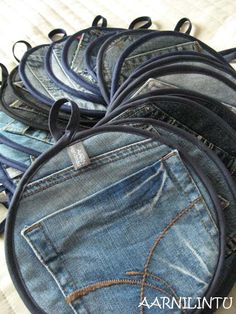 a pile of blue jeans sitting on top of each other