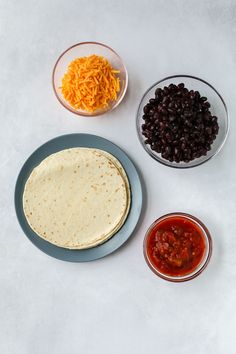 the ingredients to make an enchilada are shown in bowls