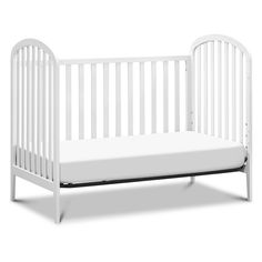 a white crib with a mattress on the bottom and side rails, in front of a white background