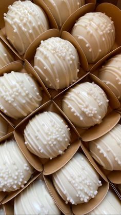 a box filled with lots of white chocolate covered donuts