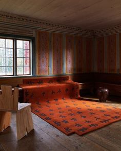 an orange rug in the middle of a room