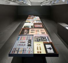 a long table with many items on it in a room that is black and white