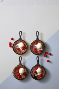 three pancakes with whipped cream and raspberries in them on a table