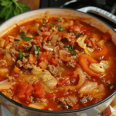 a pot filled with meat and noodles on top of a table