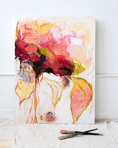 an abstract painting is shown with paintbrushes next to it