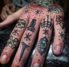 a person's hand with tattoos on it