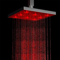 a shower head with red lights on it