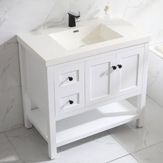 a white bathroom sink sitting next to a window