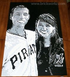 an image of a man and woman in black and white on a wood floor with a wooden table