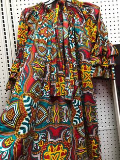 "Freesize African dress that can be worn loosely or belted. Has elastic in neck and also on ruffled sleeves. Unique one size dress fits up to 2x. Length is 35\" knee length. Comes with bonus matching mini head scarf. Fabric is 100% cotton print." Bohemian Midi Dress With Elastic Neckline, Multicolor Dress With Elastic Neckline For Vacation, Casual Multicolor Dress With Elastic Neckline, Multicolor Cotton Boho Print Maxi Dress, Multicolor Cotton Maxi Dress With Boho Print, Multicolor Boho Print Cotton Maxi Dress, Cotton Maxi Dress With Vibrant Print, Bohemian Cotton Maxi Dress With Vibrant Print, Bohemian Dresses With Bold Patterned Print