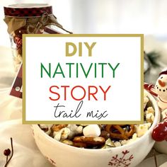 a bowl filled with nuts and candy next to a sign that says diy nativity story trail mix