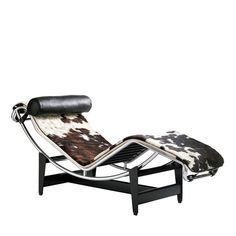 an animal print chaise lounge chair with black leather and chrome frame, viewed from the front