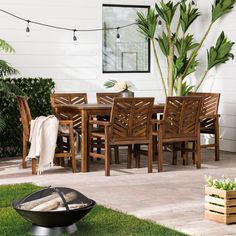 an outdoor dining table and chairs with a fire pit in the foreground