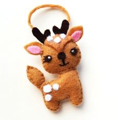 a small stuffed animal with horns on it's head is hanging from a string