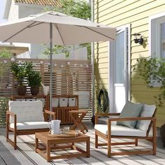 an outdoor patio with wooden furniture and umbrella