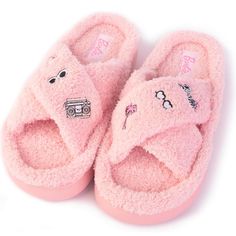 a pair of pink slippers with cartoon characters on them