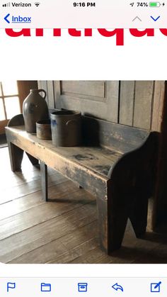 an old wooden bench with two vases on it's back and the bottom