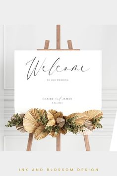 a welcome sign with flowers on it and the words, wedding written in black ink