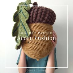 a crochet pattern for an acorn cushion