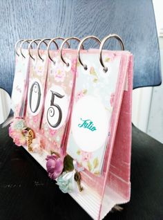 a desk calendar with flowers on it sitting on top of a table