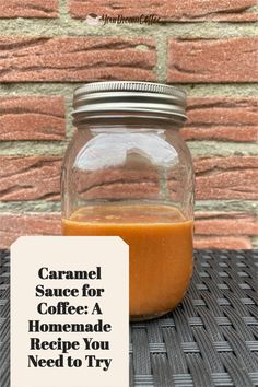 a jar filled with liquid sitting on top of a table next to a brick wall