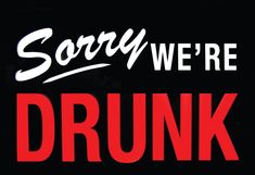 a sign that says sorry we're drunk on the side of a black background