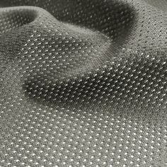 an upholstered fabric with white dots on it